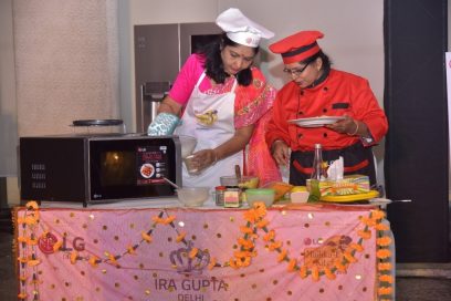 Two event’s participants cook their Indian food by using LG’s microwave ovens at the LG Mallika-E-Kitchen contest.