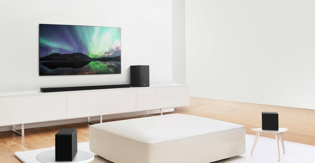 Wide-angle shot of LG SoundBar model SN11RG with 7.1.4-channel system installed under an LG TV in a modern living room setting