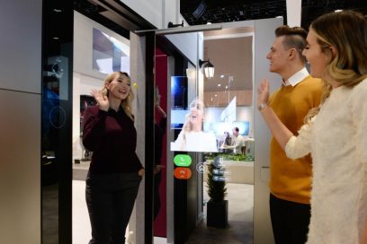 A visitor waves to her friends after using LG ThinQ’s Smart Door concept which was showcased at CES 2020