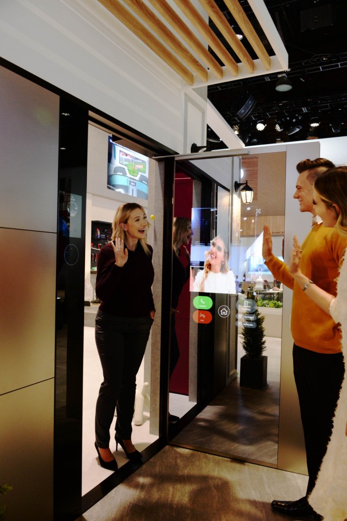Another view of a visitor waving to her friends after using LG ThinQ’s Smart Door concept which was showcased at CES 2020