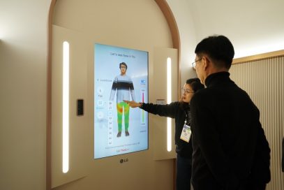An LG representative takes a visitor through the Style Lab to see how well his clothes fit at the company’s CES 2020 LG ThinQ fit Collection booth