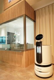 A closer look at the LG ‘CLOi’s Table’ restaurant with a server bot, and the LG CLOi CoBot ready to clean the dishes in the background, at CES 2020