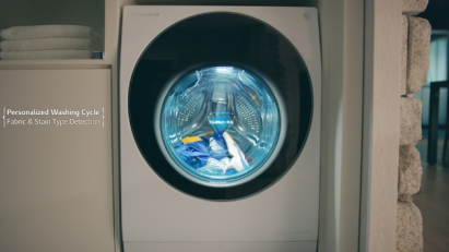 A front view of the LG SIGNATURE TwinWash washing machine running its Personalized Washing Cycle and Fabric & Stain Type Detection functions