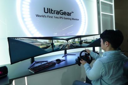 A visitor uses three wide LG UltraGear monitors side-by-side to experience an immersive racing game setup at CES 2020 with record-breaking 1ms response rates