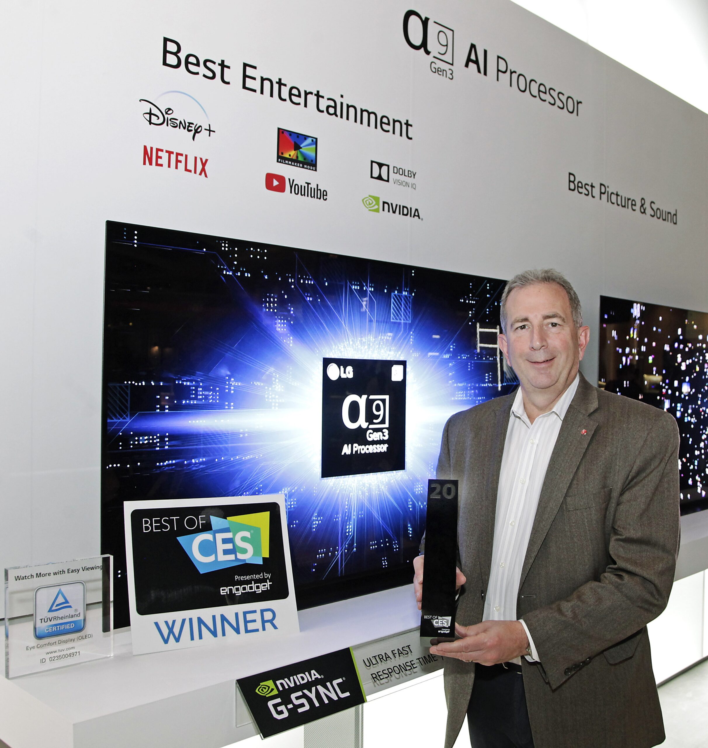 Tim Alessi, LG US’s head of marketing, holding up a Best of CES award in front of the company’s a9 Gen3 AI Processor display at CES 2020