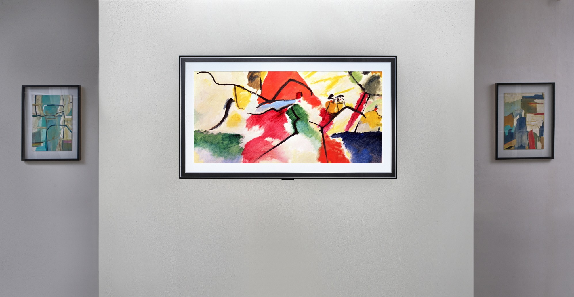 Front view of LG Gallery series model GX hanging flush on the wall of an art exhibition as it blends effortlessly in between other pieces on display