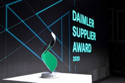 A close-up of the trophy, with the Daimler Supplier Award 2020 Logo displayed behind