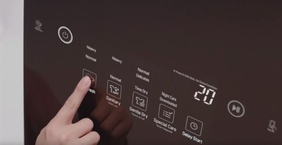 A close-up of someone pushing the Refresh button on the LG Styler’s display panel to eliminate germs and bacteria from their clothes