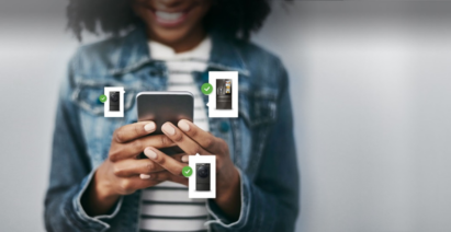 A girl smiles as she monitors her home appliances from a smartphone