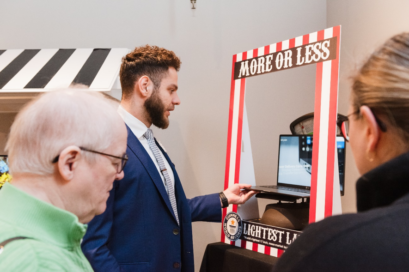 A man weighs the LG gram on the scale placed inside its ‘More or Less’ display