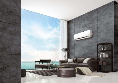 LG DUAL COOL placed on the wall of a modern living room by the ocean