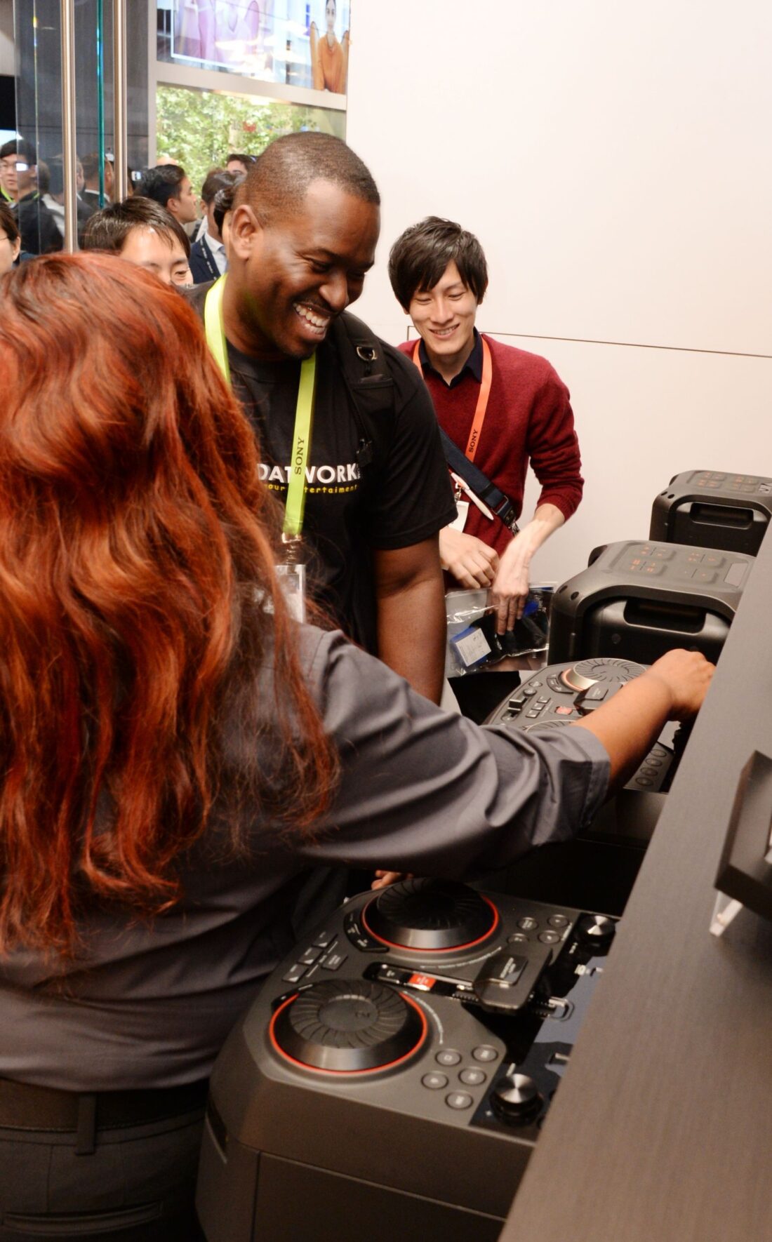 Some CES attendees try out the turntables and crossfaders on LG’s XBOOM Speaker.
