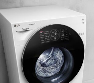 Left-side front view of the LG washing machine featuring TrueSteamTM technology as it runs a cycle
