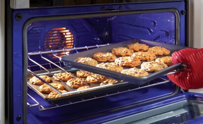 A tray of cookies is being taken from the LG Oven, with baking made easy via its LG ProBake Convection ®