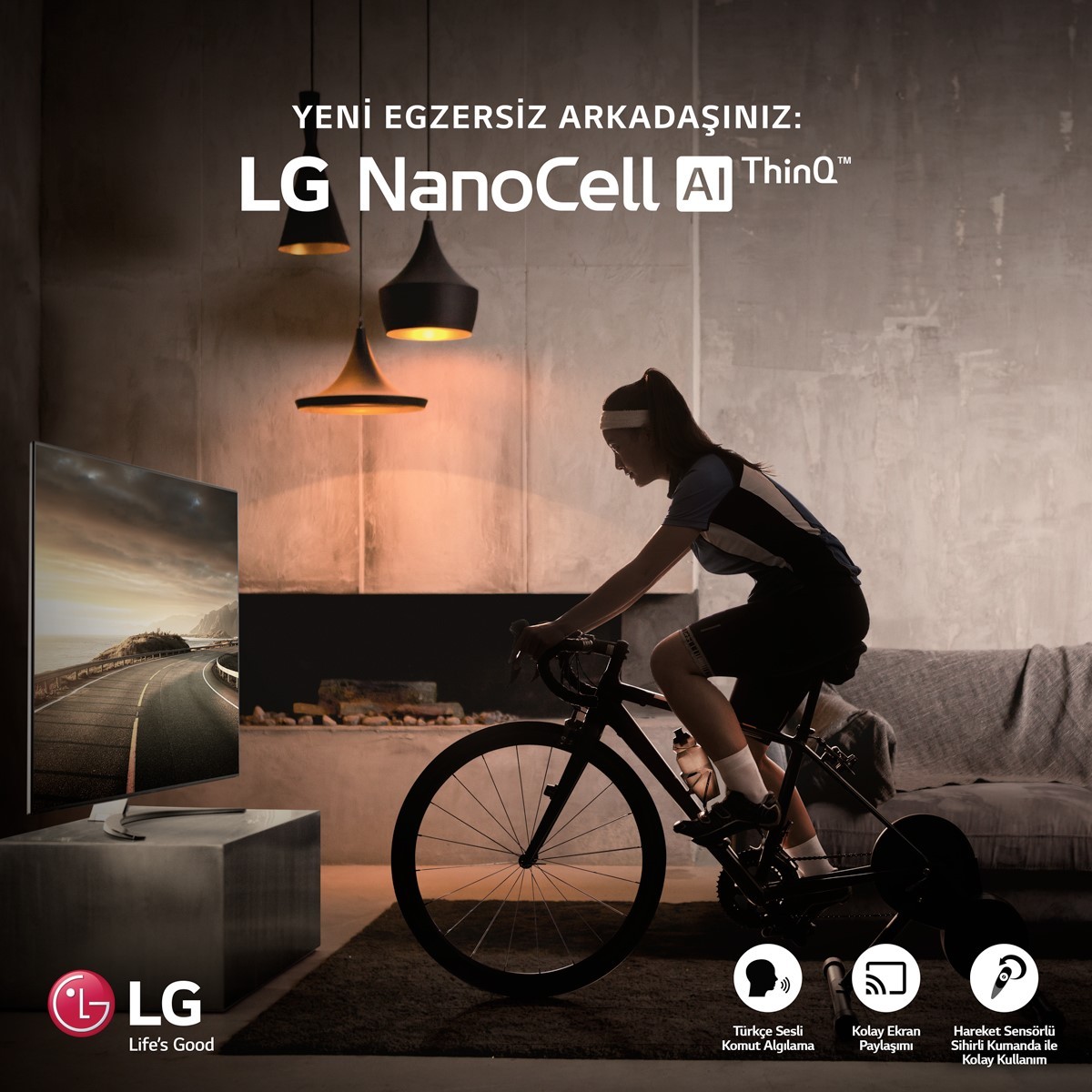 A woman participates in the LG Indoor Cycle Challenge by riding her bike in front of her living room LG NanoCell TV