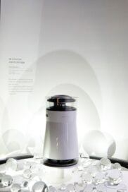 Front view of the LG SIGNATURE Air Purifier in front of the information display about the product