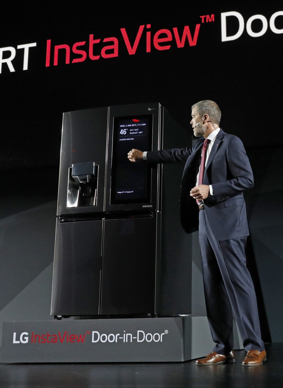 David VanderWaal, Senior Vice President, Marketing, LG Electronics demonstrates the InstaView feature of LG's InstaView Door-in-Door refrigerator at its CES 2017 Press Conference.