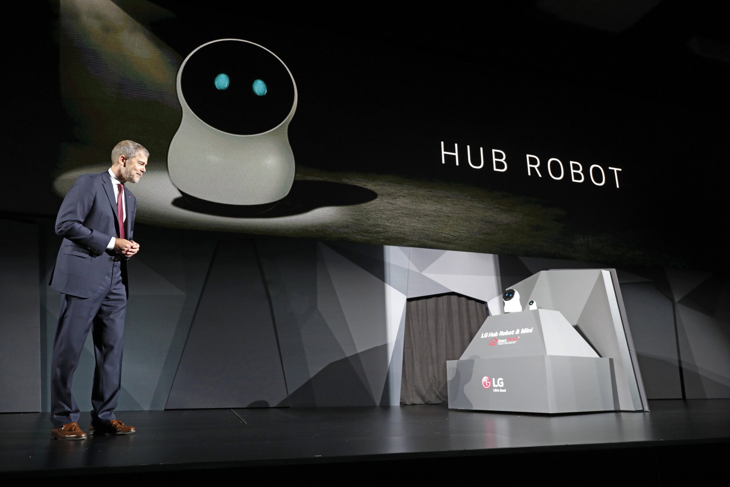 David VanderWaal, Senior Vice President, Marketing, LG Electronics interacts with LG's CLOi Hub Robot at its CES 2017 Press Conference.