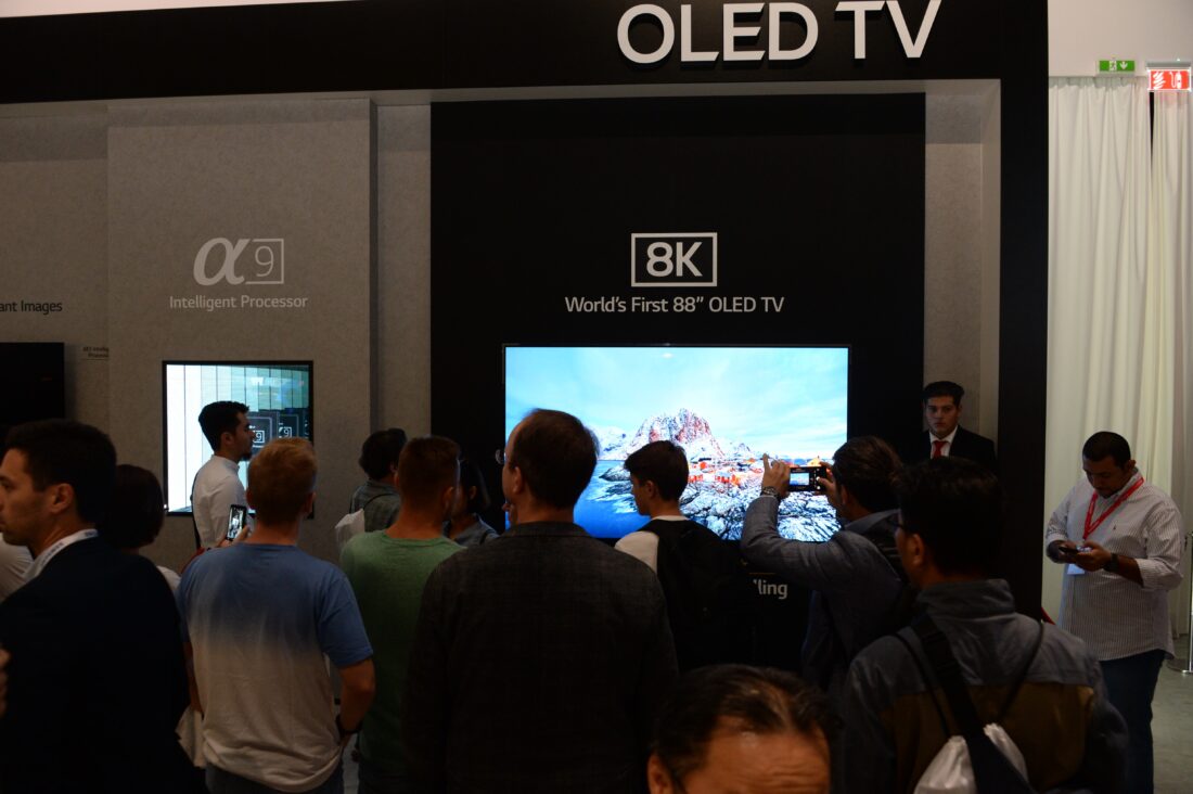 World’s First 8K OLED TV with A9 Intelligent Processor display zone at IFA 2018 with conference attendees walking around and looking at the display