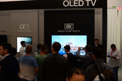 World’s First 8K OLED TV with A9 Intelligent Processor display zone at IFA 2018 with conference attendees walking around and looking at the display