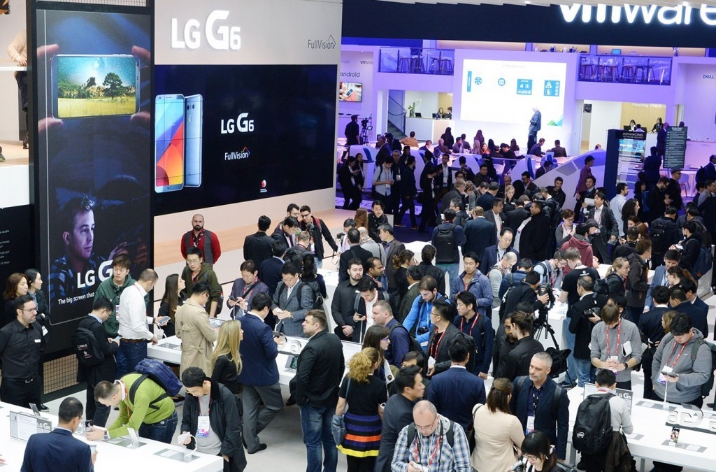Conference attendees walk around and test out the products at the LG's MWC 2017 booth.