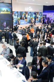 Closer view of conference attendees walking around and testing out the smartphones at LG's MWC 2017 booth