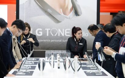 Close view of visitors testing out the LG TONE Flex Premium Bluetooth headsets at the LG TONE Studio zone at MWC 2017
