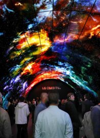 Attendees at CES 2017 walk under the LG OLED Tunnel, admiring the high picture and sound quality of LG's OLED TVs.