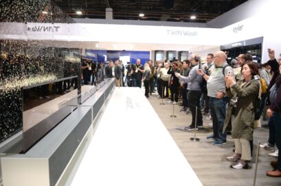 Side view of LG SIGNATURE OLED TVR display zone with CES visitors viewing the display and taking pictures