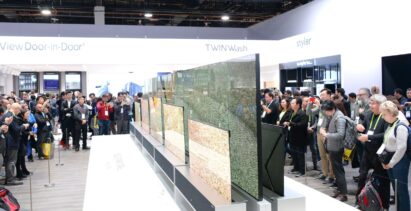 Another view of LG SIGNATURE OLED TVR display zone with CES visitors viewing the display and taking pictures