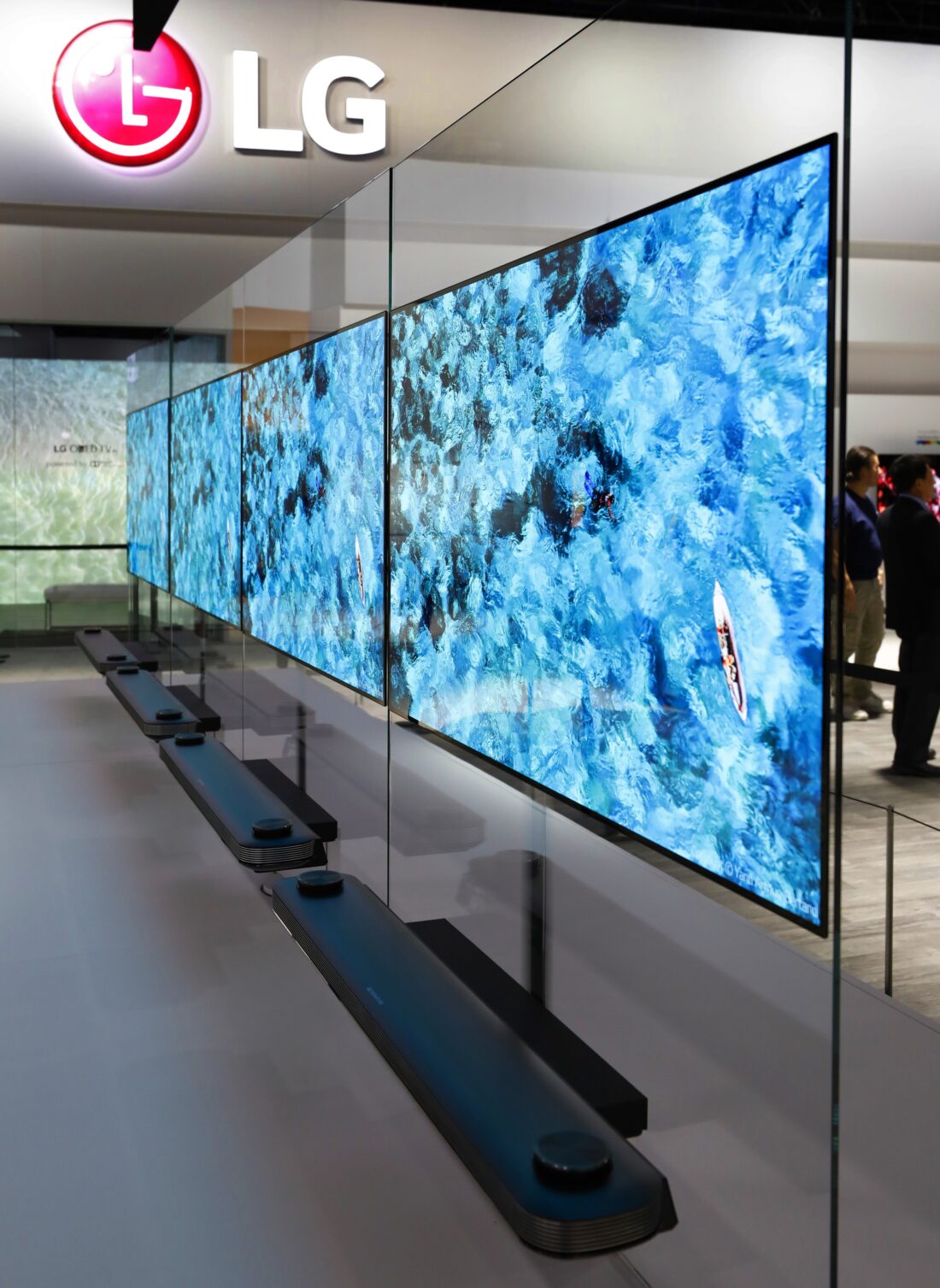 Close-up side view of four sets of the LG SIGNATURE OLED TV W positioned side by side at LG's CES 2017 booth