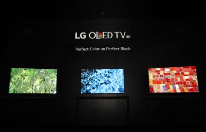 Three LG OLED TV models demonstrate the perfect colors and perfect black in a dark room at LG's CES 2017 booth.