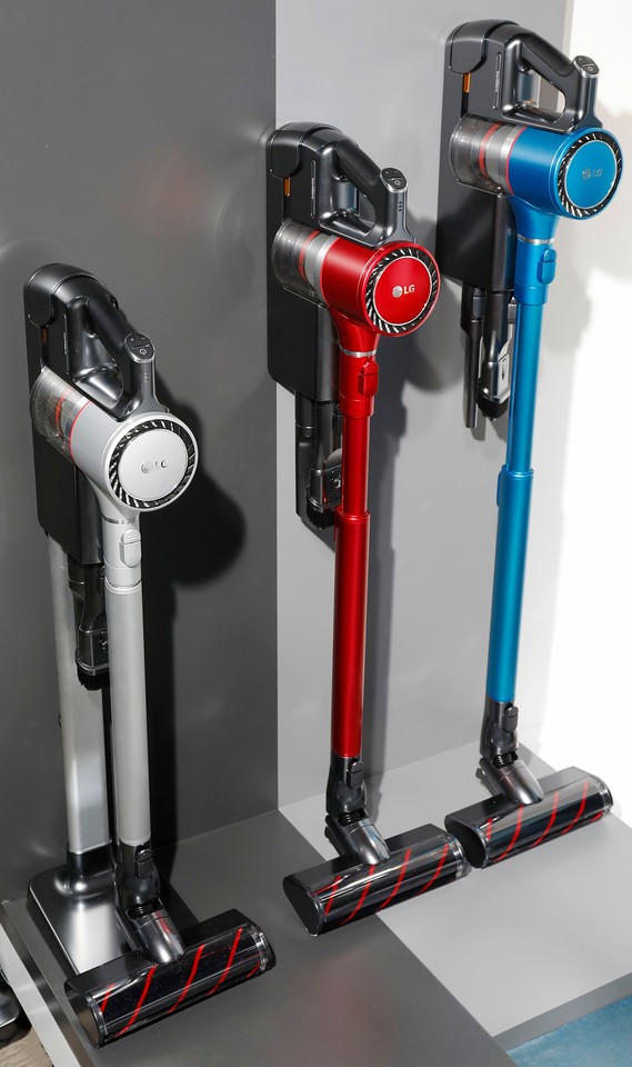 Three LG cordless vacuum cleaners in three different colors on display at LG's CES 2017 booth