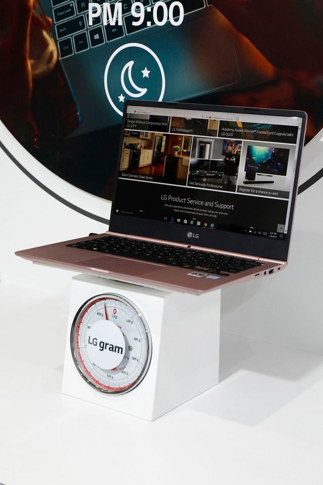 The LG gram laptop computer is weighed on a scale at LG's CES 2017 booth.