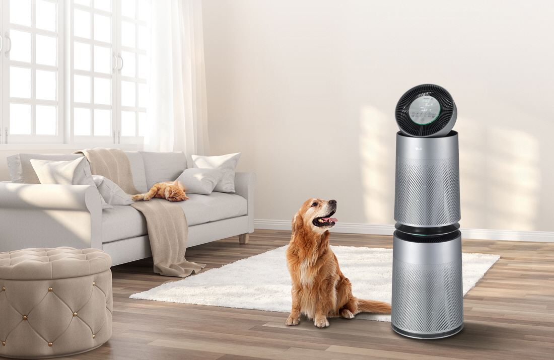 LG PuriCare Air Purifier Pet standing by a dog with a long, fluffy hair in a living room