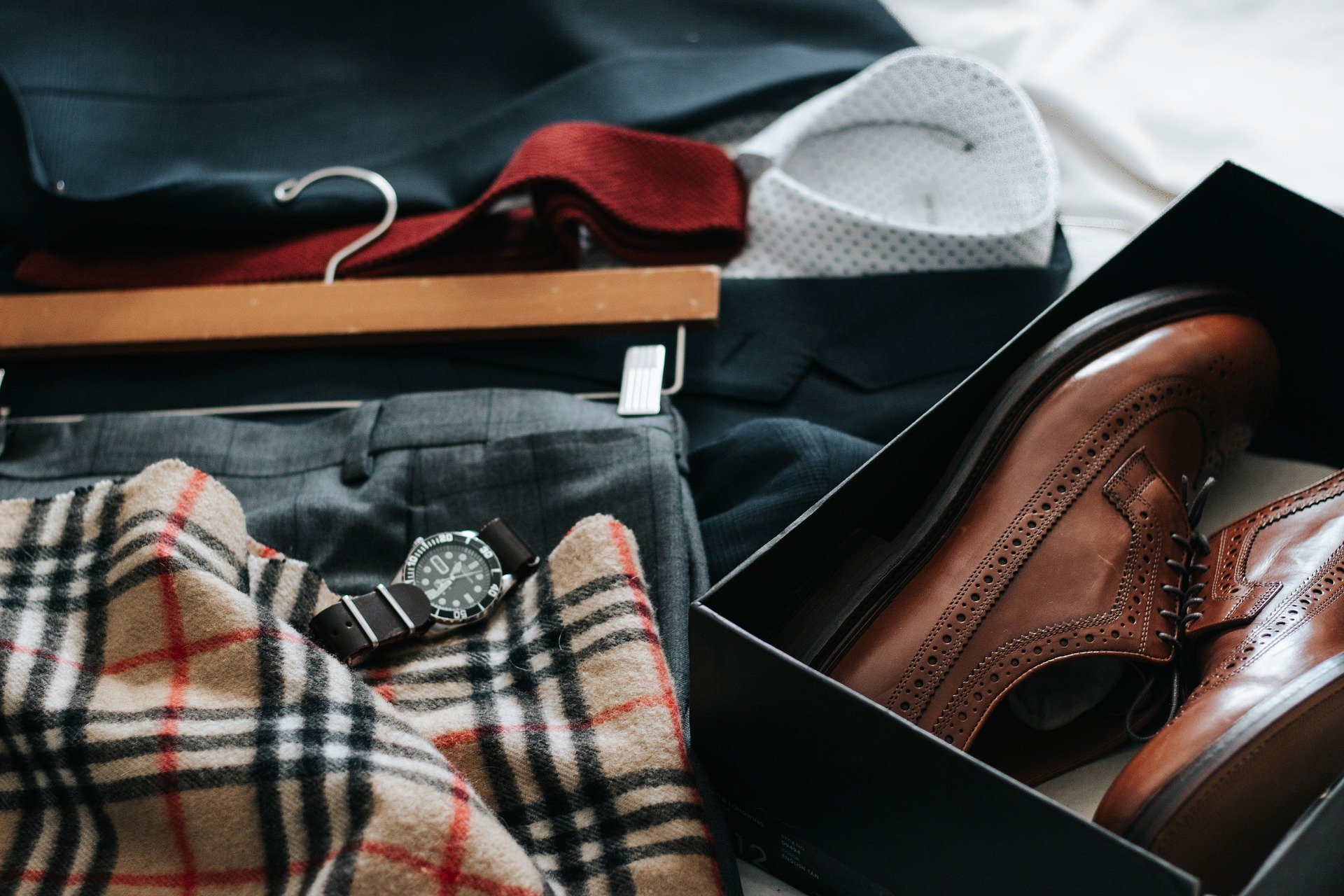 An array of smart clothes and shoes laid on a bed