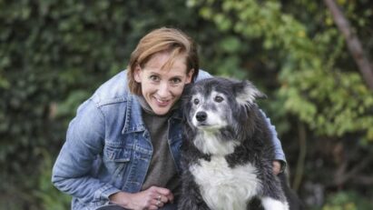 Jennifer Hunt poses with a dog that benefited from the Pet Medical Crisis Fund