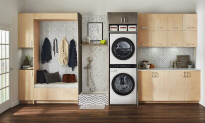 The white LG WashTower fitted inside a modern room with wooden furnishings and next to a shower designed specifically for pets