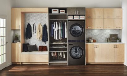 The black LG WashTower fitted inside a modern room with wooden furnishings and next to a space designed to store your clean clothes after washing