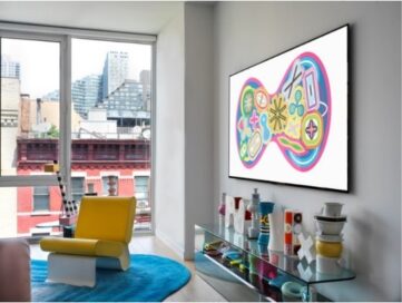 A room with a view is decorated with colorful items and the wall-mounted LG GALLERY DESIGN TV which is displaying Karim Rashid’s KOSMOS