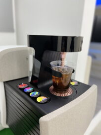 The capsule coffee machine in the IONIQ Concept Cabin making a cup of coffee for a passenger