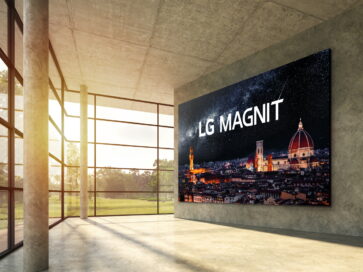 A modern interior space boasting natural light from its expansive windows has LG MAGNIT hanging on the wall, the new Micro LED signage solution displaying a beautiful, crystal-clear night scene of Italian city Florence