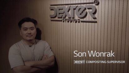 Wonrak Son, head of the composition team at Dexter Studios, is standing beside his company’s logo