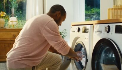 A man taking clothing out of his LG washing machine