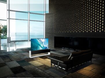 LG SIGNATURE OLED R positioned inside a modern living room in its Full View mode, bringing the realistic viewing experience of watching ocean waves crashing