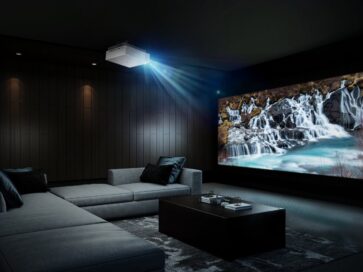 The LG CineBeam attached to the ceiling of a dark home cinema room delivers high-resolution imagery of a waterfall and the perfect movie theater experience