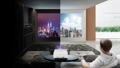 A man uses LG CineBeam in his living room to view a vivid day & night Kuala Lumpur skyline in both light and dark room conditions