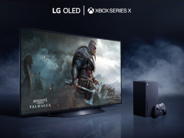 LG OLED TV placed in a dark room filled with mysterious smoke as it displays a battle scene from Assassin's Creed Valhalla, the latest video game available on LG official partner Microsoft’s Xbox Series X console which is seen to the right of the TV