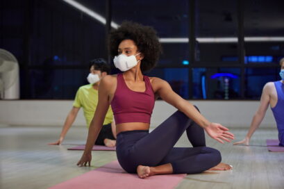 People wearing LG PuriCare™ wearable Air Purifier while stretching