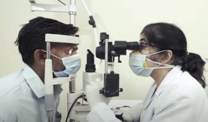 A doctor providing the proper medical care needed by giving a patient a thorough eye exam